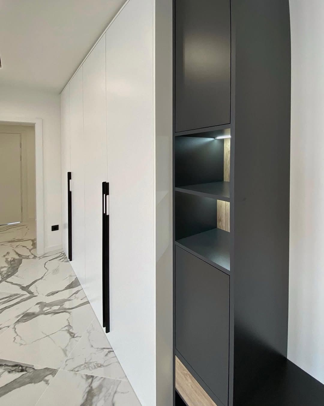 Detail: black display shelving over Calacatta-look porcelain - bespoke joinery by Royalwoods Interiors, Tatu City, Kiambu