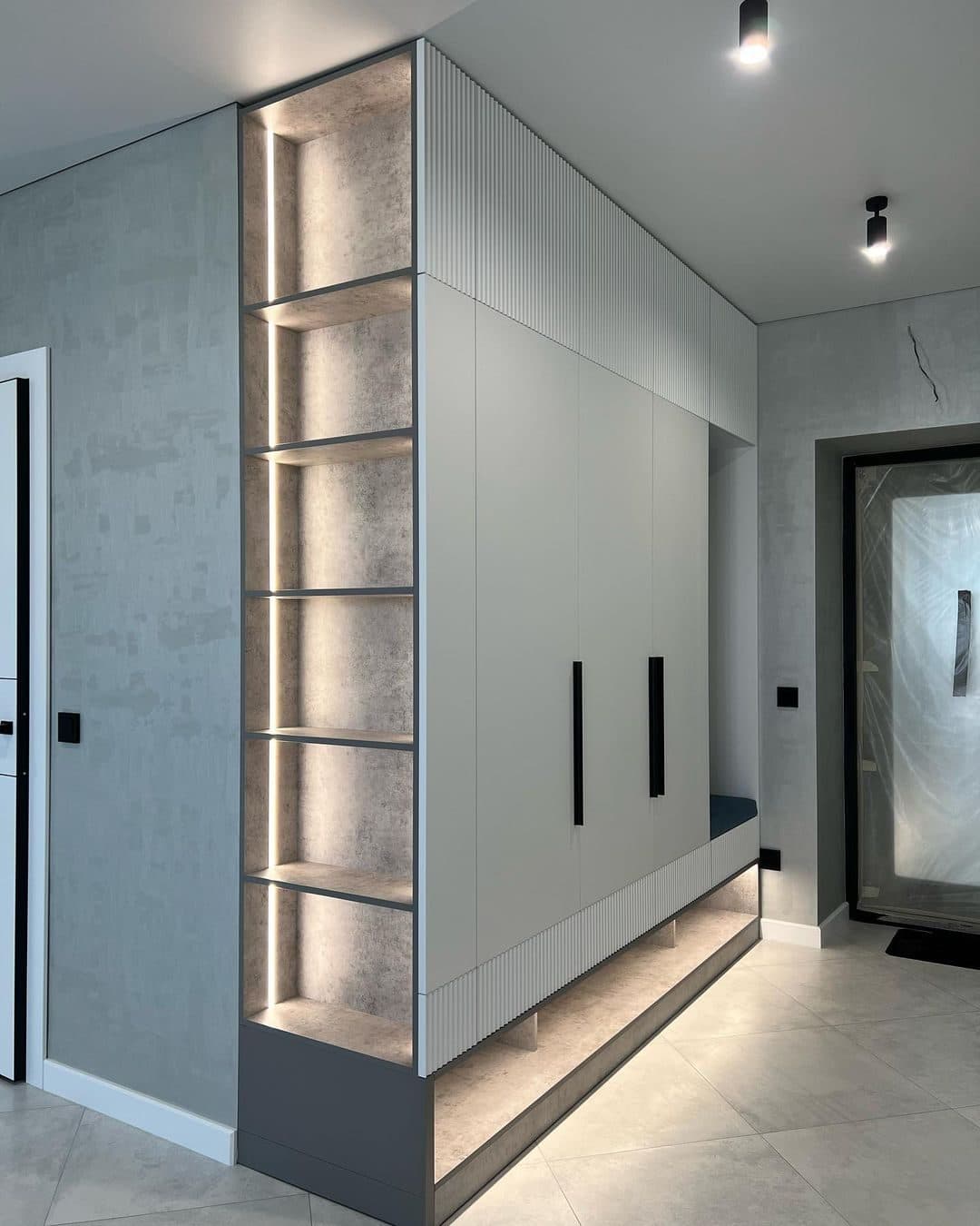 Full-height entry column with edge-lit display shelving - bespoke joinery by Royalwoods Interiors, Nairobi