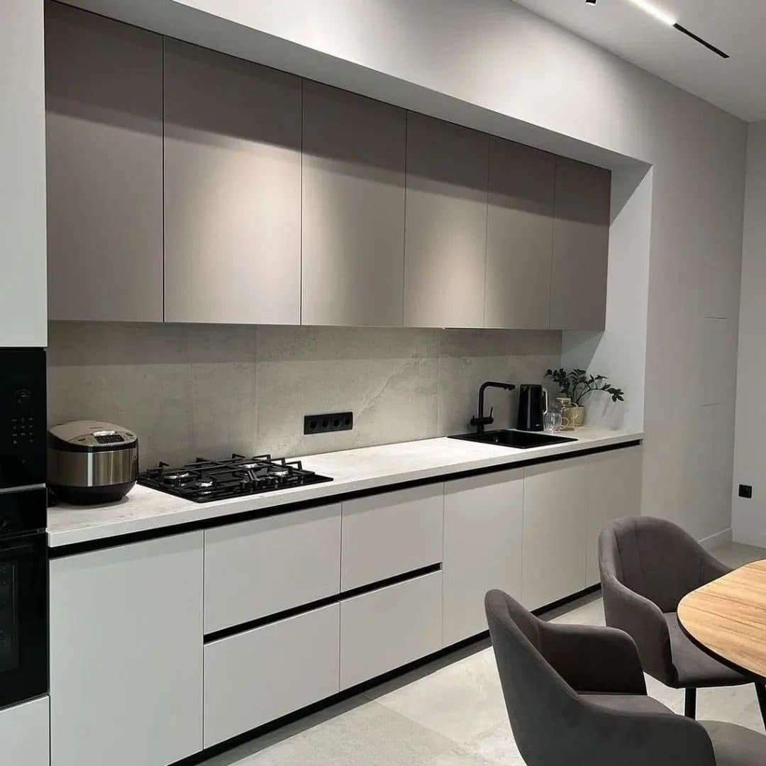 Long greige kitchen run with black tapware and integrated hob - bespoke joinery by Royalwoods Interiors, Nairobi