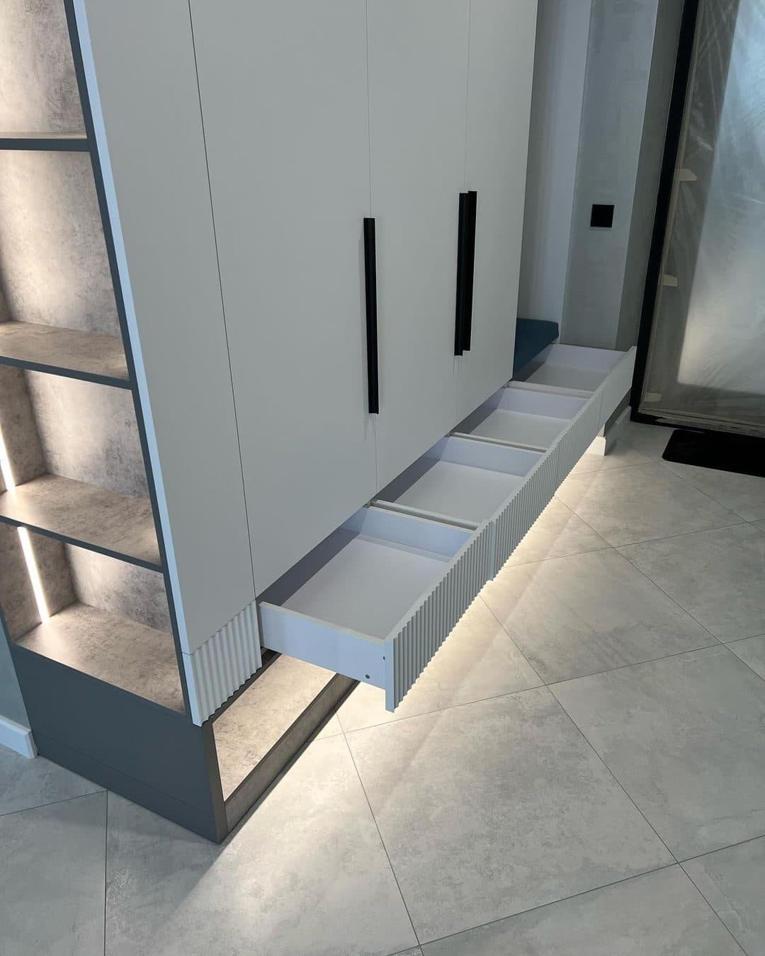 Detail: soft-close hallway drawers and LED-lit shelf column - bespoke joinery by Royalwoods Interiors, Nairobi