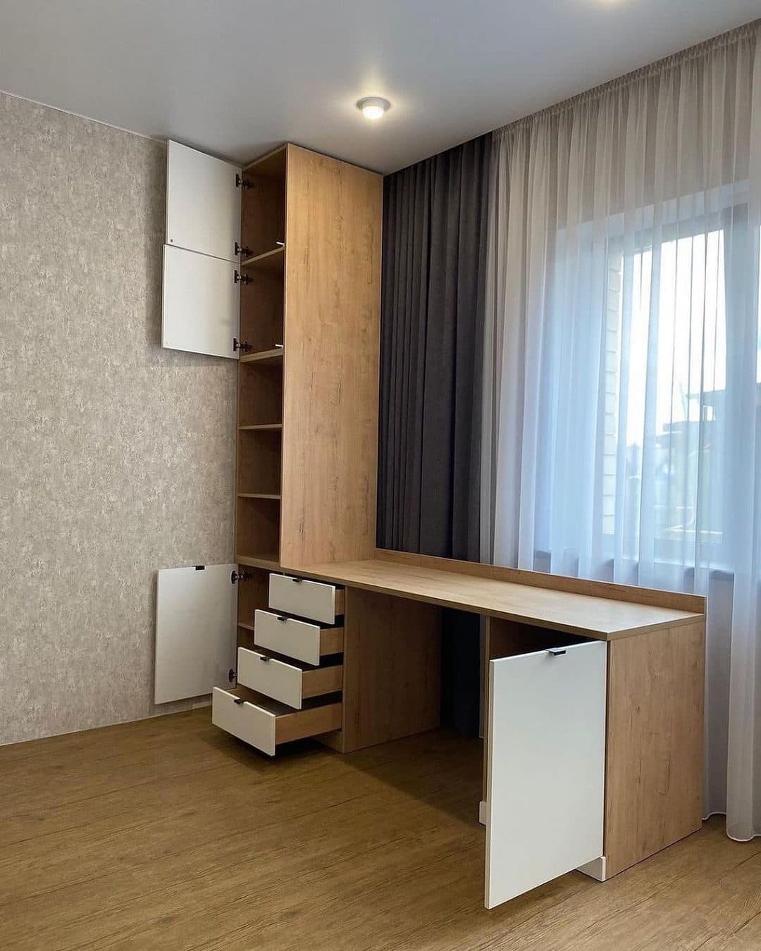 Compact oak workspace by the window with wardrobe storage above - bespoke joinery by Royalwoods Interiors, Nairobi
