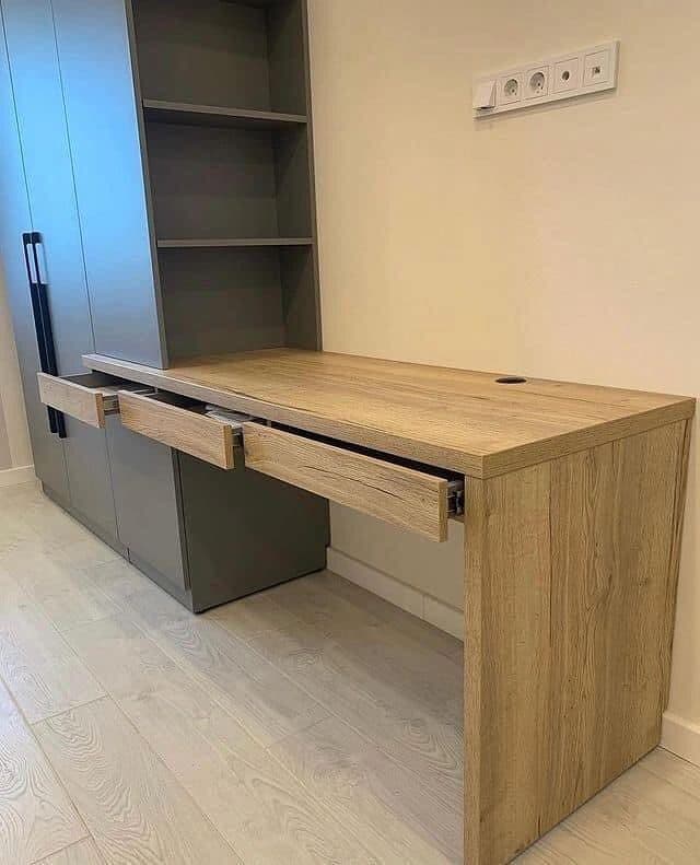 Home office: pull-out oak desk concealed within a graphite wardrobe wall - bespoke joinery by Royalwoods Interiors, Nairobi