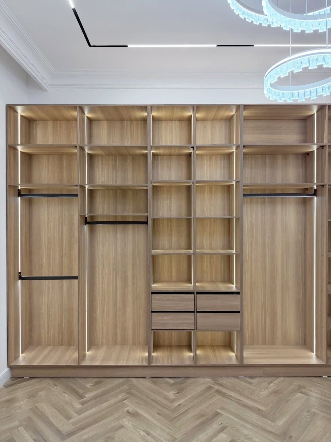 Open oak walk-in system with LED-lit shelving, hanging rails and drawer banks - bespoke joinery by Royalwoods Interiors, Nairobi