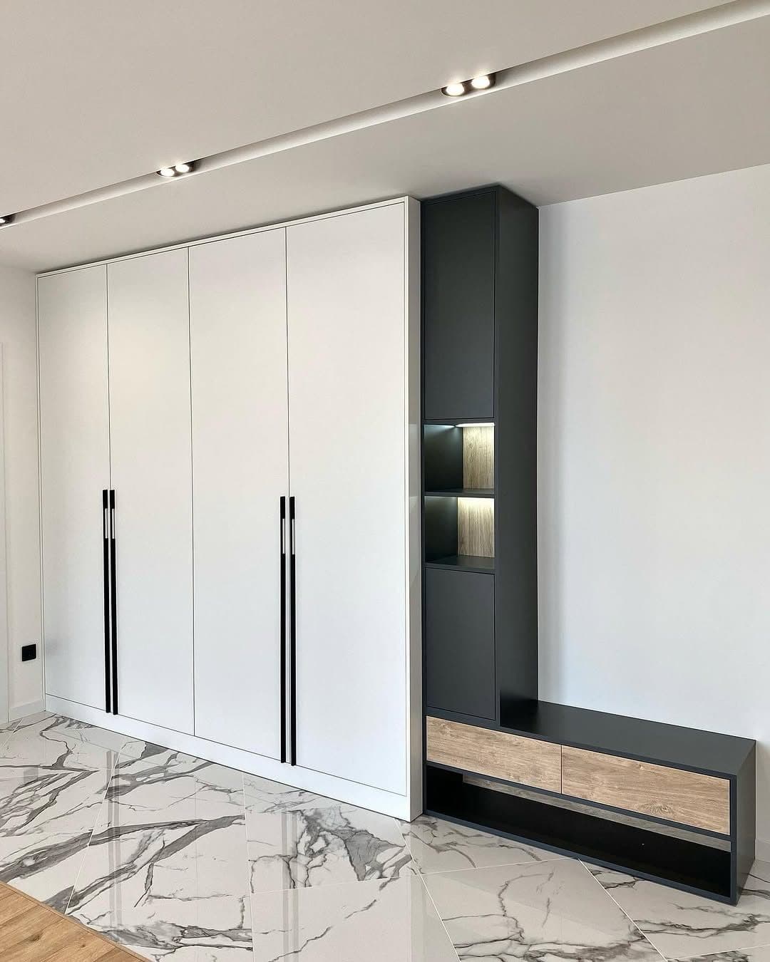 White wardrobe wall with black display column and floating oak bench on marble - bespoke joinery by Royalwoods Interiors, Tatu City, Kiambu