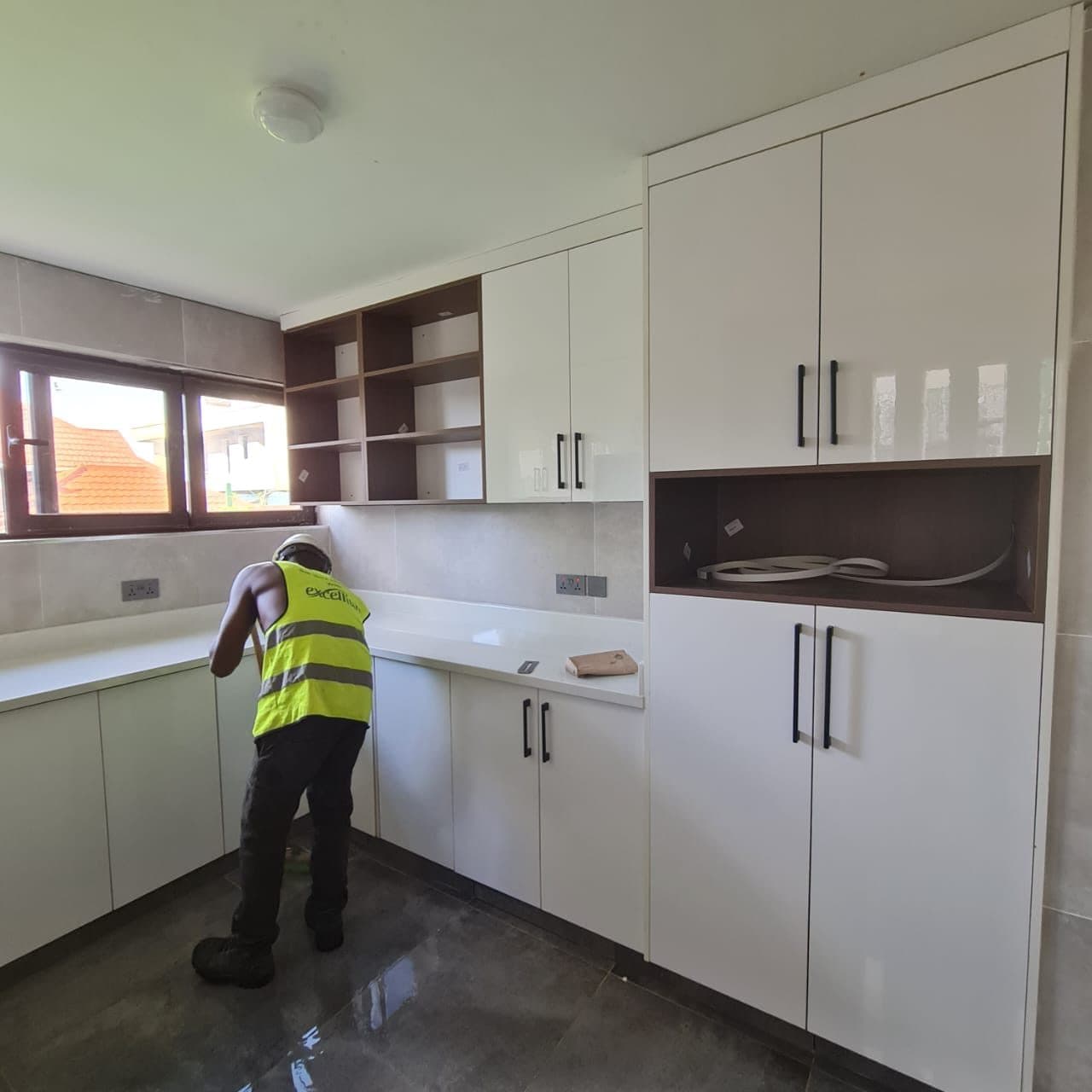 Levelling the worktop line before final fixing - tolerance checks at every stage - bespoke joinery by Royalwoods Interiors, Nairobi