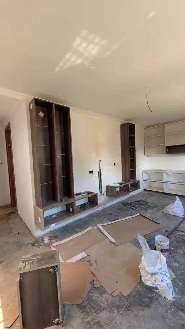 Walkthrough of the villa living room mid fit-out, TV wall framing in progress