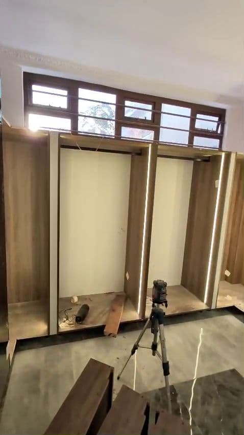 LED-lit wardrobe carcasses being fitted on site by Royalwoods Interiors