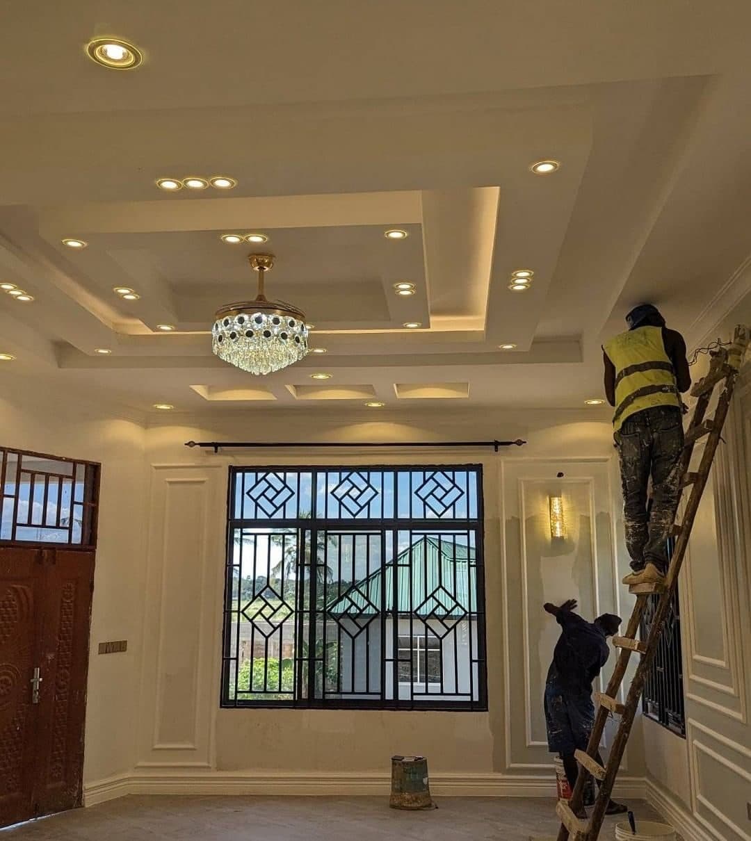 Royalwoods artisans detailing a layered gypsum tray ceiling by hand on a Nairobi site