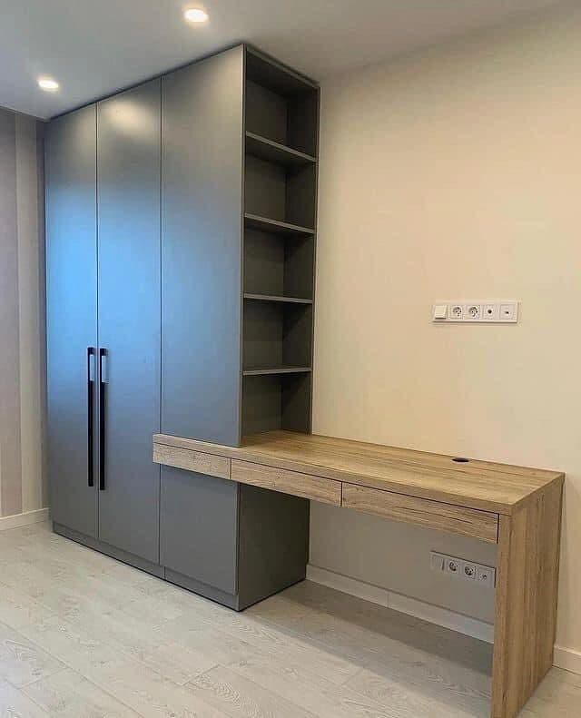 Private study with graphite wardrobe wall and oak desk return in Muthaiga by Royalwoods Interiors
