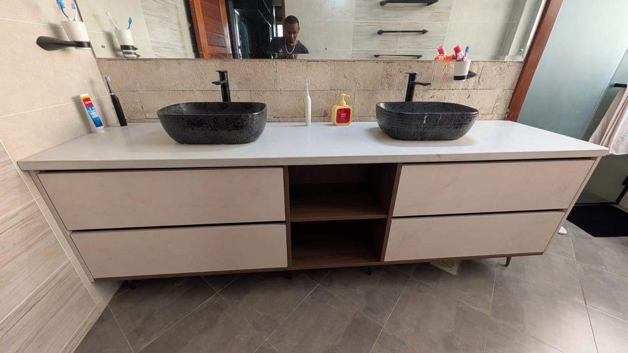 Full width of the double vanity, both basins mirrored above - bespoke joinery by Royalwoods Interiors, Nairobi