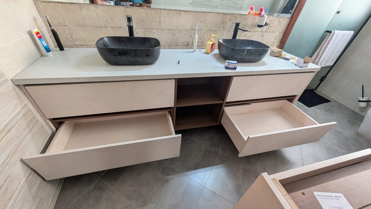 Soft-close drawers drawn open to show full-depth storage either side - bespoke joinery by Royalwoods Interiors, Nairobi