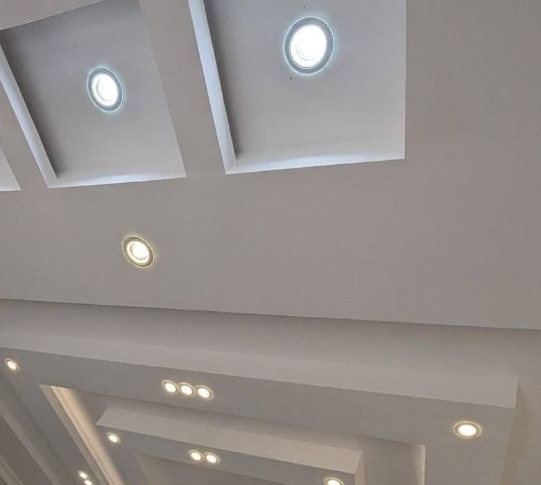 Stepped gypsum tray ceiling with recessed coffers and downlights - Royalwoods Interiors, Nairobi