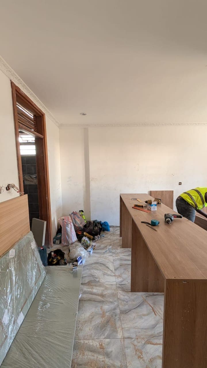 Kitchen island first fix with floor protection during a Nairobi interior fit-out