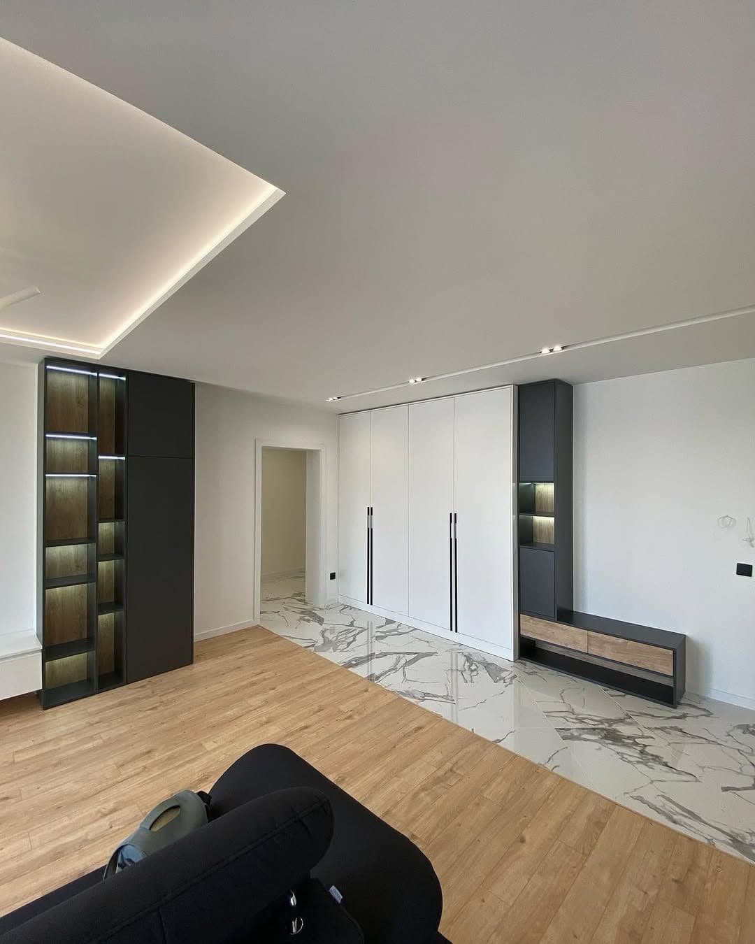 Completed living space with coffered LED ceiling and integrated media wall at the Royalwoods Tatu City project