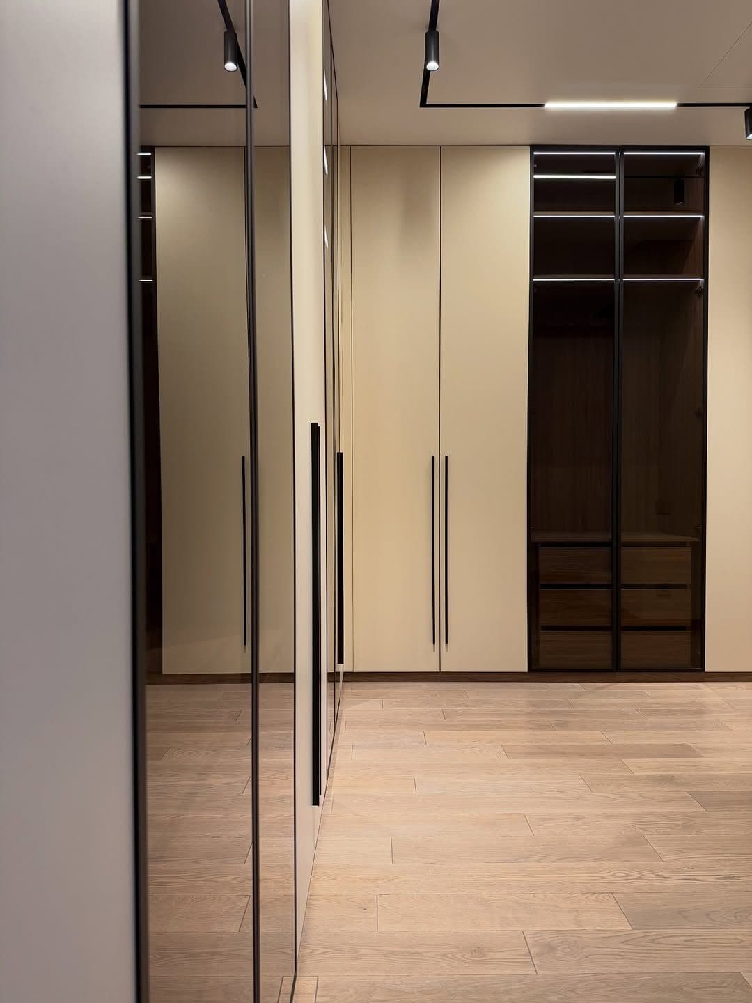 Full-height wardrobe with mirrored panel in a compact Nairobi apartment bedroom