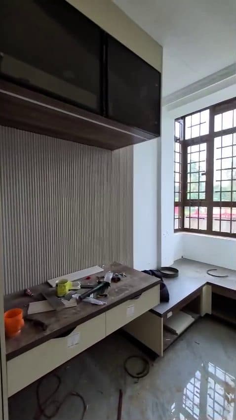 Fluted panelling, a floating desk and dark upper cabinets going in — Royalwoods Interiors, Nairobi
