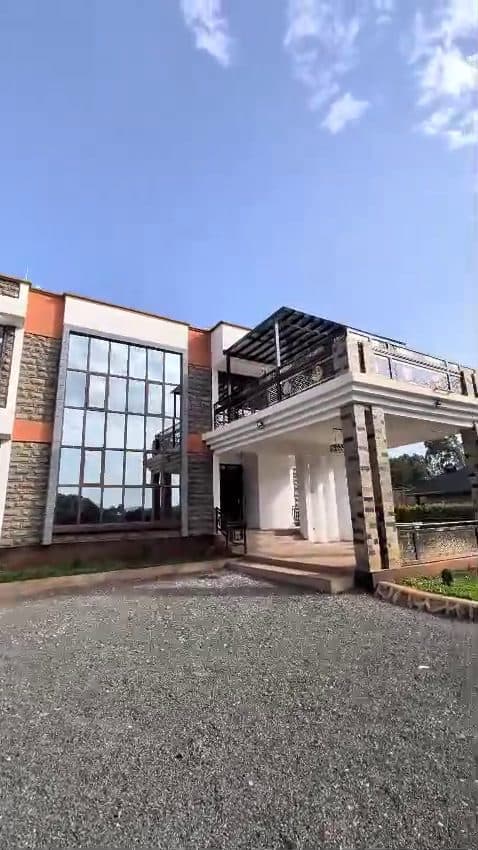Full-height glazing, a steel pergola and a gravel forecourt — Royalwoods Interiors, Nairobi