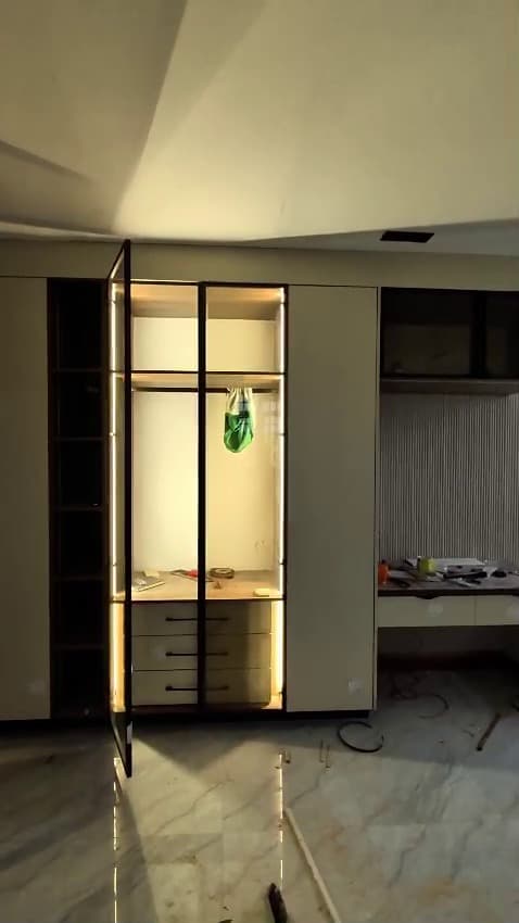 Fluted panelling, a floating desk and dark upper cabinets going in — Royalwoods Interiors, Nairobi