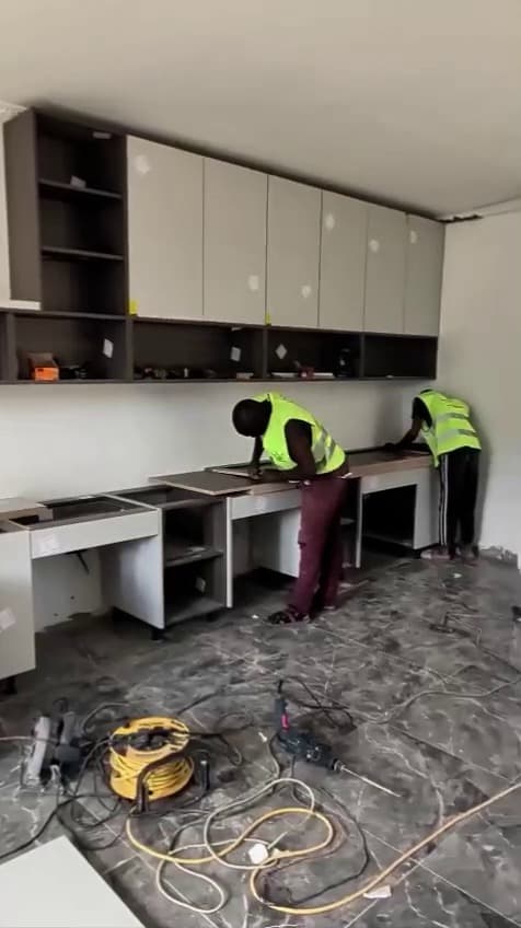 Our own craftsman, in our own hi-vis, fitting our own joinery. Nothing here is subcontracted. — Royalwoods Interiors, Nairobi