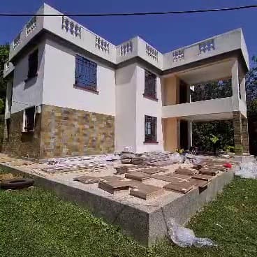 Cladding up, floor tiles dry-laid and numbered before a single one is fixed. Sequence is everything. — Royalwoods Interiors, Nairobi