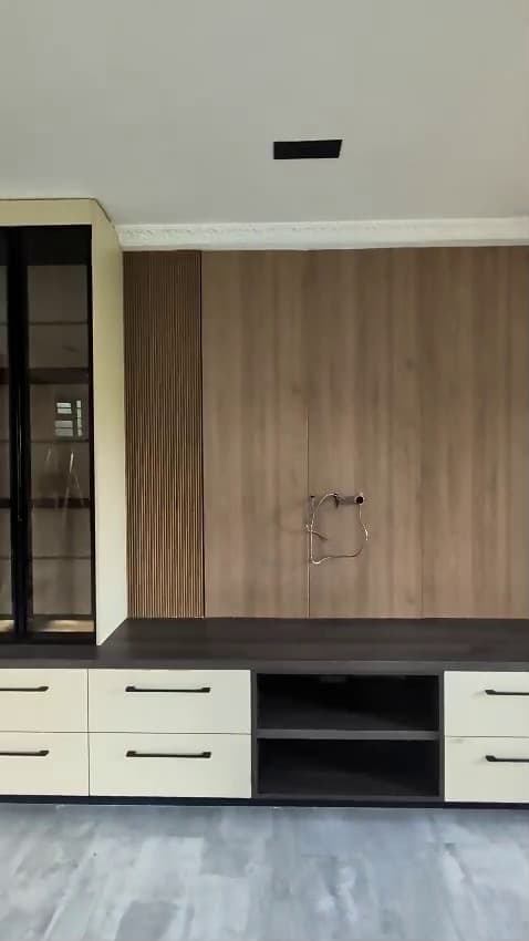 Walnut media wall with cream drawer bank by Royalwoods Interiors, Nairobi