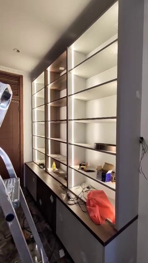 LED-lit wardrobe carcasses being fitted on site by Royalwoods Interiors