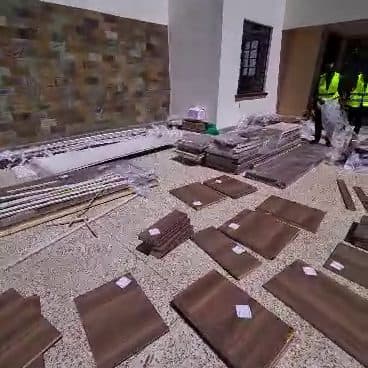Cladding up, floor tiles dry-laid and numbered before a single one is fixed. Sequence is everything. — Royalwoods Interiors, Nairobi