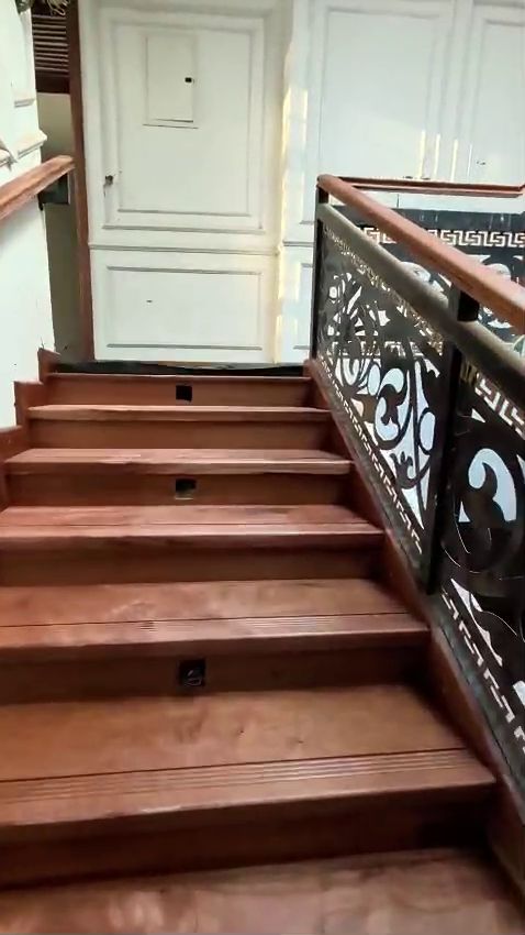 Mahogany staircase with laser-cut balustrade panels in a Kitisuru residence by Royalwoods Interiors