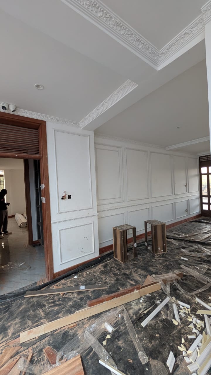 Full-height classical wall panelling and wainscoting in a Runda living room